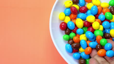 colorful chocolate covered candies in a white bowl