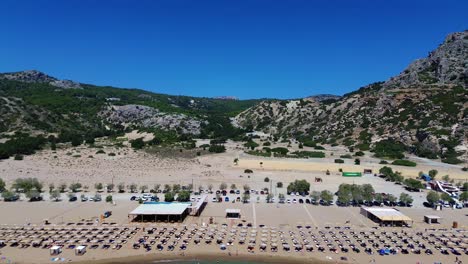 tsambika beach in faliraki, rhodes in greece filmed with the drone from above with mediterranean sea in the summer holiday