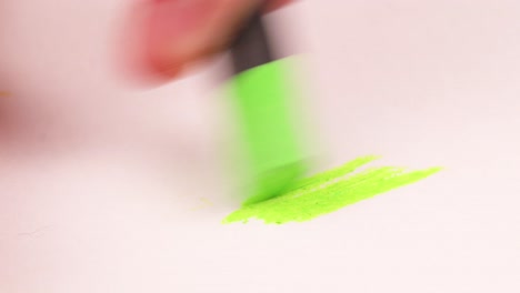 drawing with a lime green crayon on a piece of paper