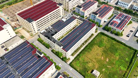aerial view of industrial area with extensive rooftop solar panels