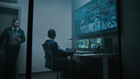 security personnel monitoring surveillance systems
