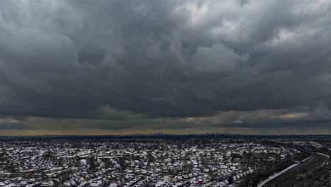 An-aerial-time-lapse-of-gray-clouds-over-a-suburban-neighborhood-on-Long-Island,-New-York-on-a-cloudy-day