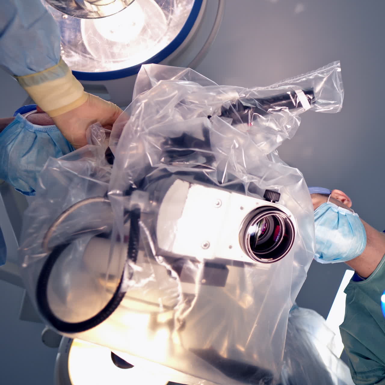 Neurourgeons are operating with medical robotic surgery machine. Manual control by Minimally Invasive Surgical System. Modern automated medical device. Surgical room in hospital with robotic technology equipment, machine arm neurosurgeon. Closeup of neurosurgery machine.