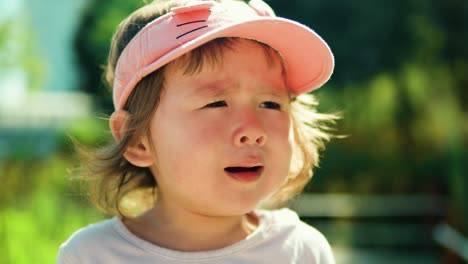 displeased toddler girl crying outdoor - portrait slow motion