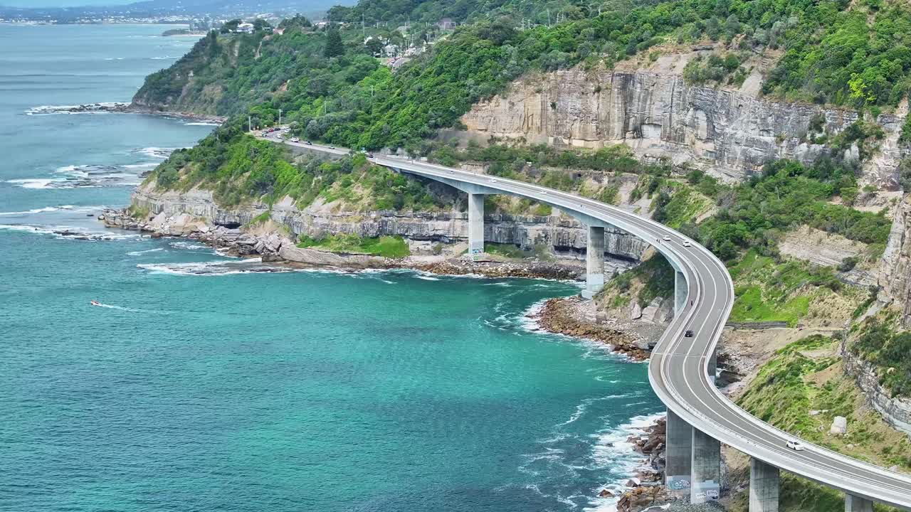 Elevated view of Sea Cliff Bridge hugging the cliffs above the Pacific Ocean in Australia