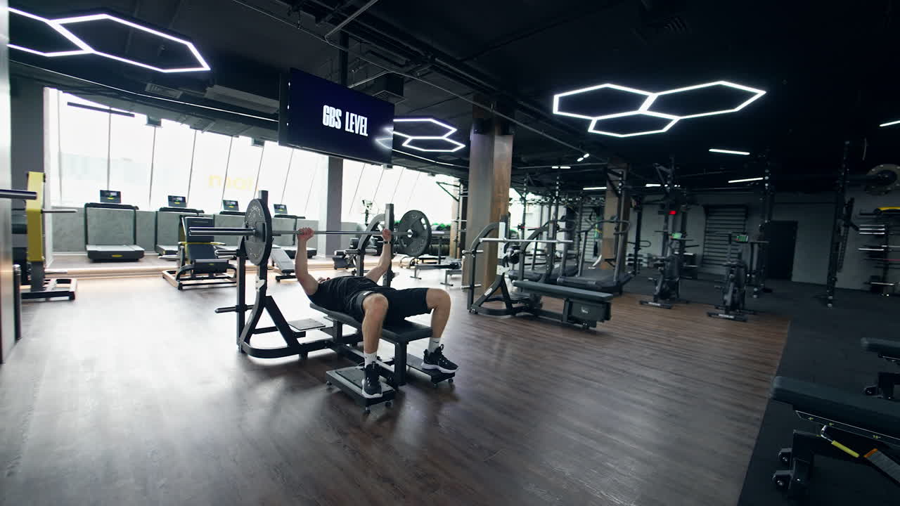 Man Bench Pressing in Modern Gym