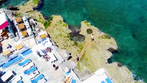 Tourists-Enjoying-At-The-Scenic-Coast-Of-Anfeh-In-Lebanon---aerial-orbit