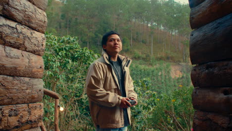 man taking pictures in a mountain cabin