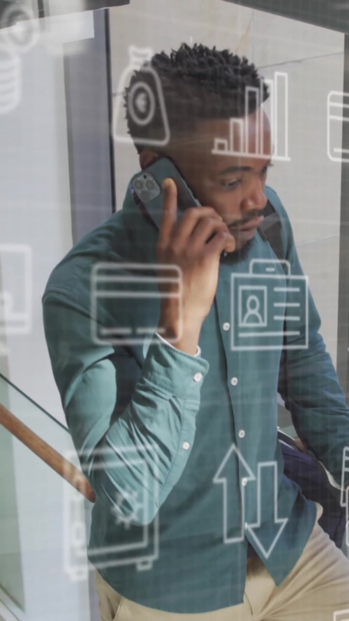 Animation of icons and data processing over african american businessman in office