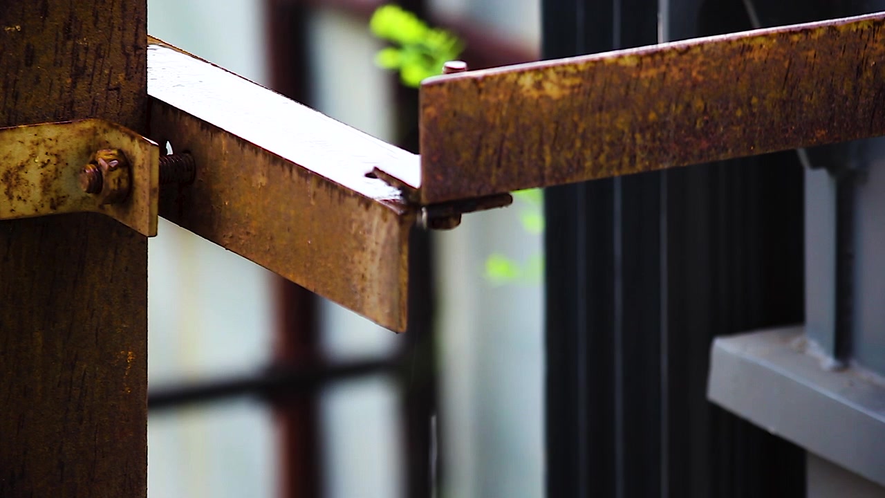 Rusty steel beam dripping rainwater after rainfall. Ideal for construction, infrastructure, engineering, weather, industrial maintenance, corrosion and environmental projects.