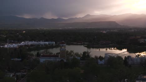 aerial footage of lakewood and the mountains during sunset