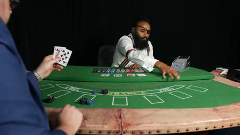 poker player beating black jack dealer in a casino winning chips