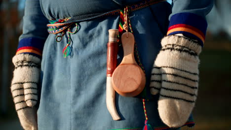 sami people in traditional clothing with knife and drinking cup on its belt. - closeup shot