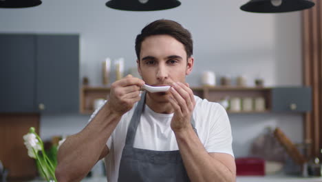 Chef-man-smelling-seafood-at-home-kitchen.-Joyful-man-cook-enjoying-food-indoors