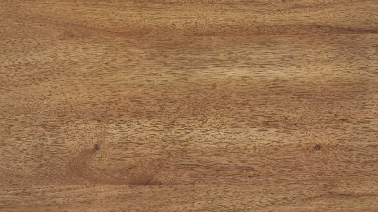 Camera zooms slowly, revealing fine wood grain across tabletop