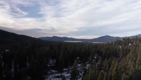 wide rising aerial shot of big bear lake during the winter in southern california