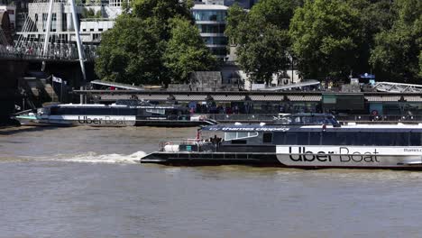 uber boat cruising along the river thames