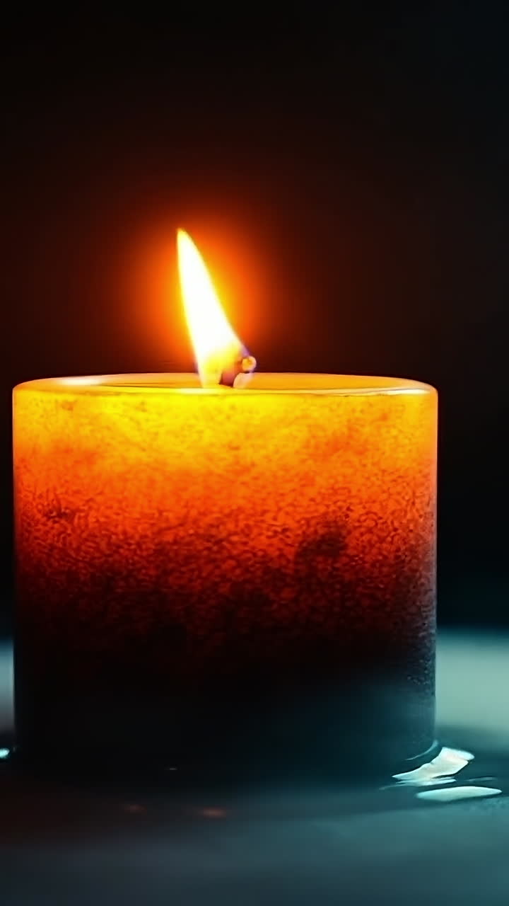 Bright candle light in dark surroundings. A flickering candle emits warm light, casting shadows and creating a calm, intimate atmosphere in low light conditions.