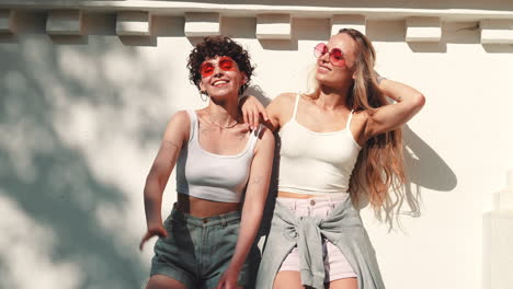 two women friends posing outdoors