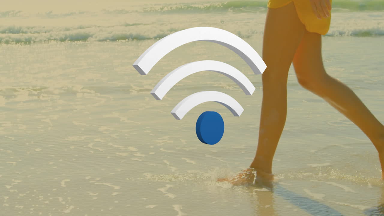 Wi-Fi symbol animation over person walking along sandy beach shoreline