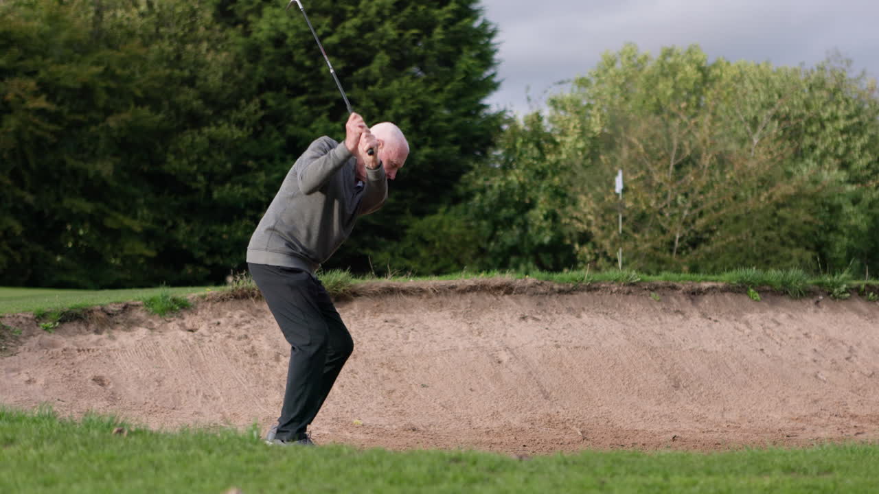 Golfer playing out of sand trap