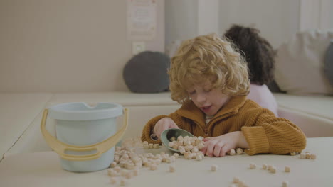 little kids with wooden cubes