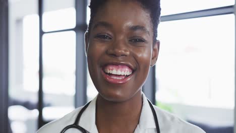 portrait of african american female doctor looking at camera and smiling