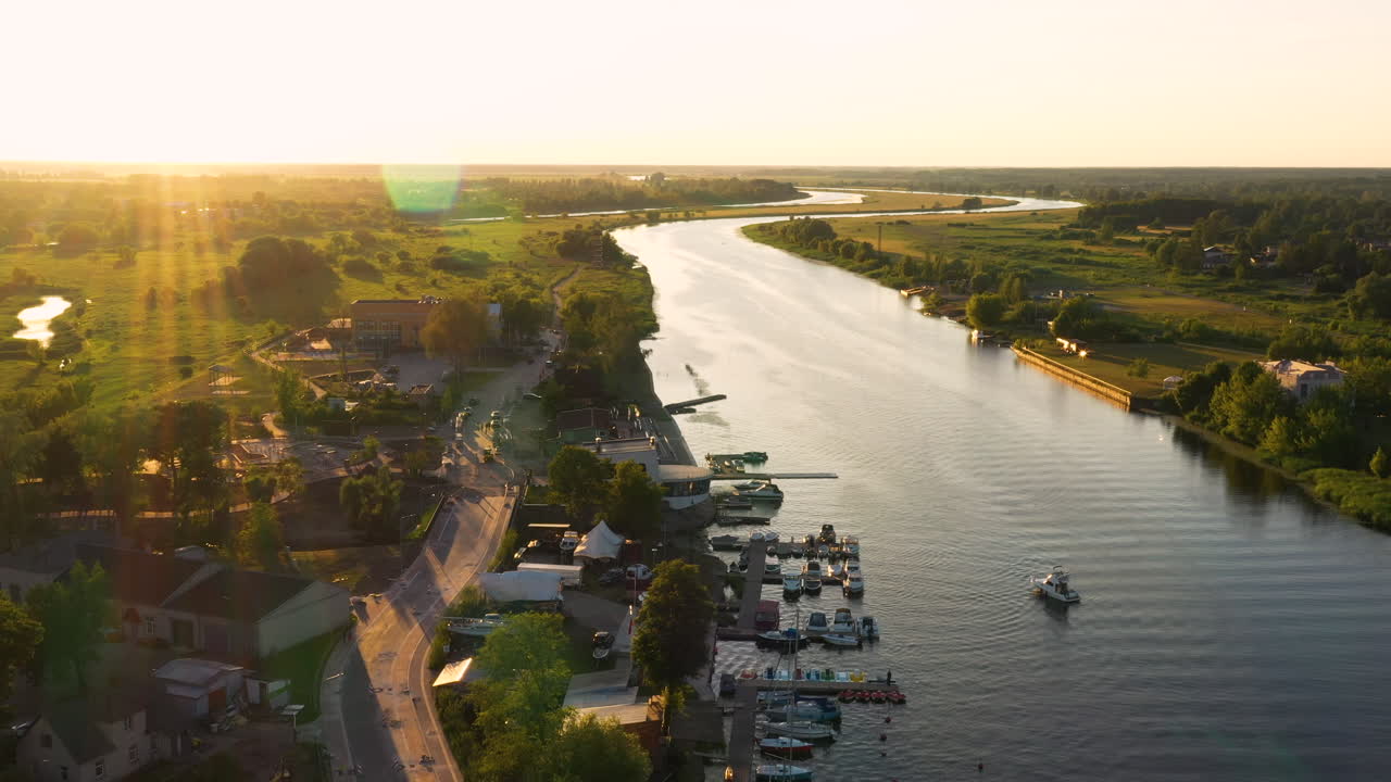 Aerial sunset view of riverside with boats and scenic landscape