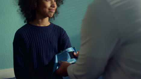 pediatrician puting tonometer cuff on teen kid arm closeup. girl talking doctor