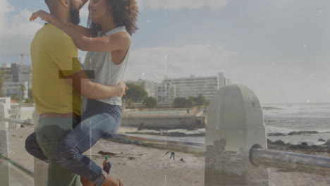 couple embracing seaside railing while showcasing animated building charts for business marketing