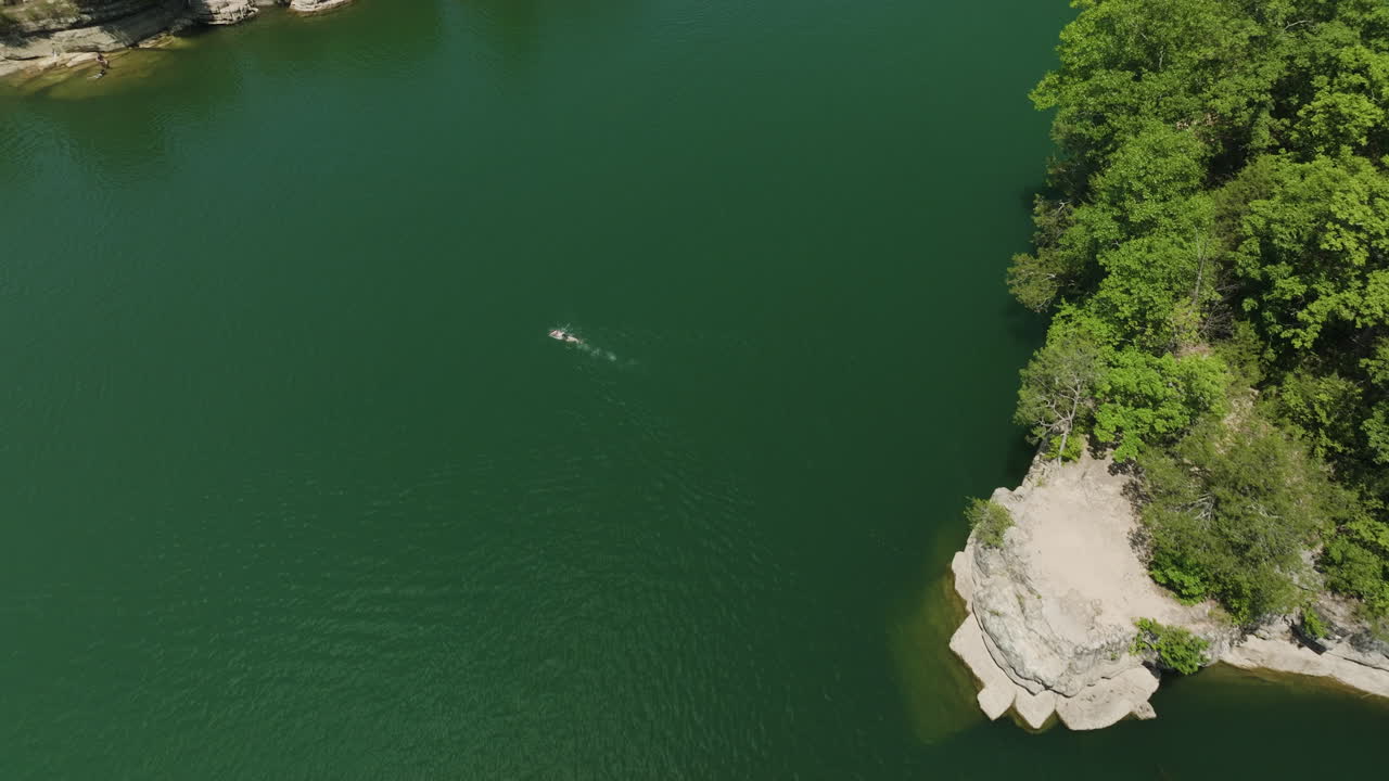 Drone Splashdown, a bird's eye view of a person swimming in Beaver Lake, Hogscald Hollow, Arkansas, USA