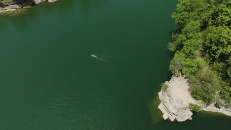 drone splashdown, a bird's eye view of a person swimming in beaver lake, hogscald hollow, arkansas, usa