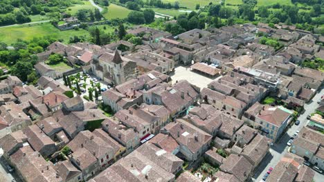 monpazier town france pull back drone aerial reverse reveal