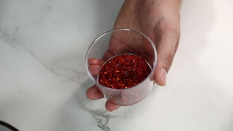 preparing a cocktail with red pepper flakes