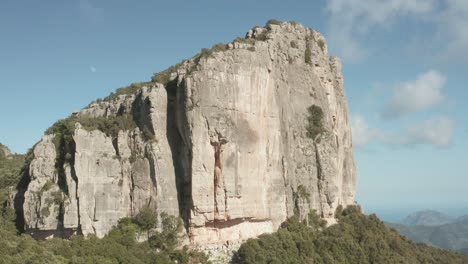 rock climbing at limestone rock formation in sardinia, italy