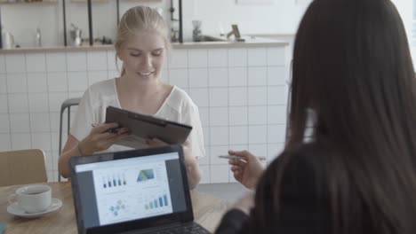 young female customer taking agreement from financial advisor