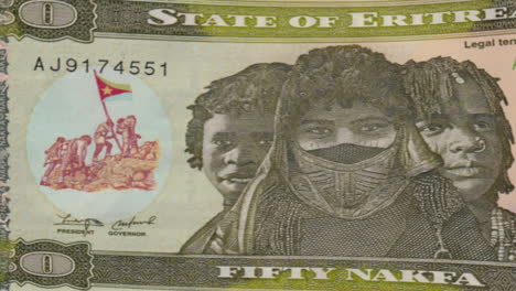 eritrean fifty nakfa banknote with portraits and port scene on green screen