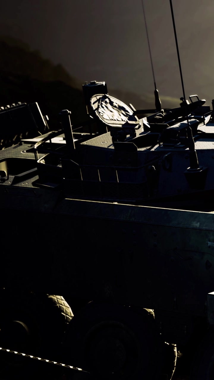 Military vehicle on duty at sunset near a mountainous region