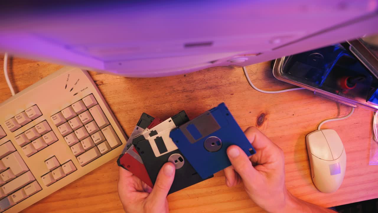 Using diskette for old computer. Music recorder, playing retro computer games. Vintage device for office, obsolete technology. . High quality 4k footage