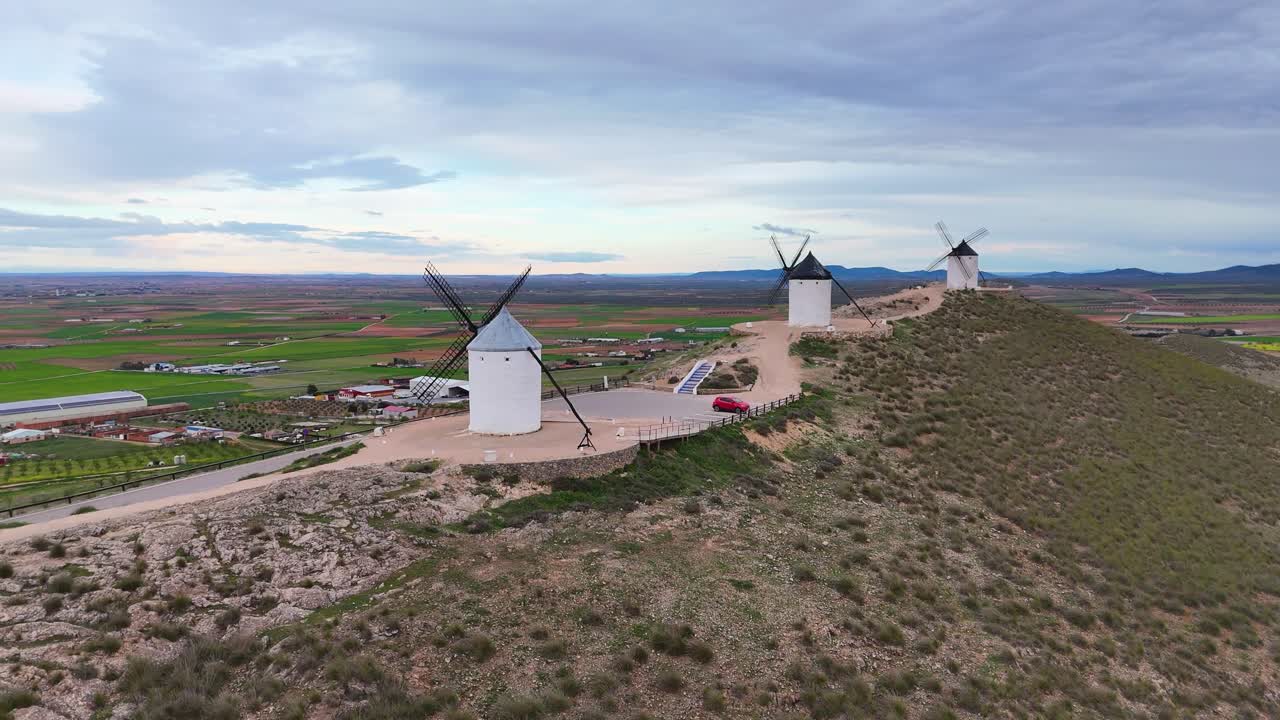 Drone films windmills on hill in Consuegra Spain