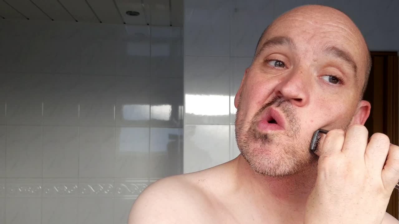 Male shaves with an electric razor