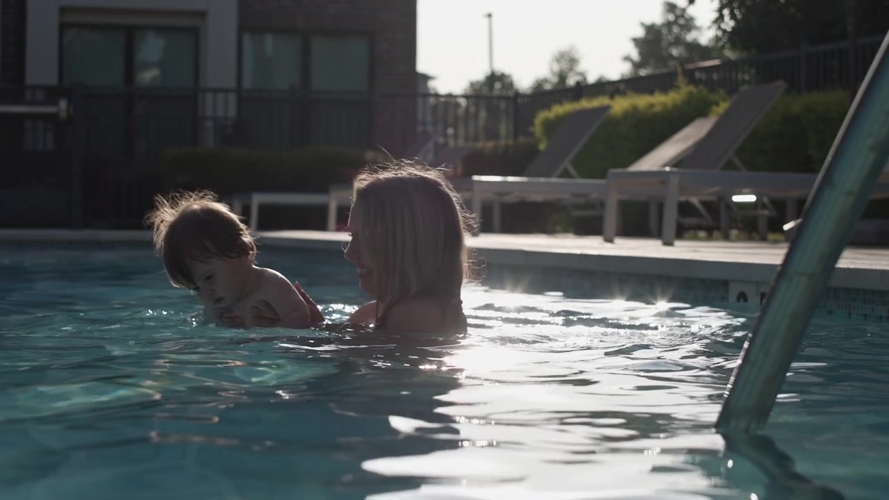 Cinematic lighting of a mom and son at the pool together