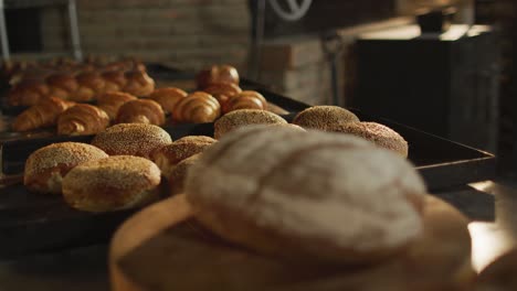 Animation-of-close-up-of-fresh-baked-breads-and-rolls-at-bakery