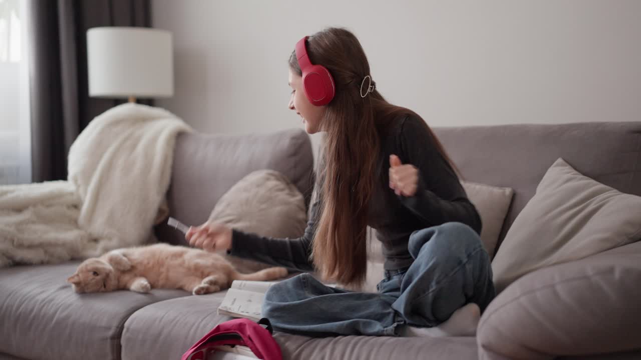 Girl listening to music with her cat