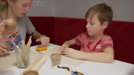 boy and art teacher at a clay workshop