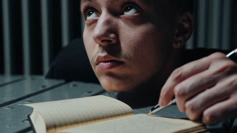 a man writing in a notebook