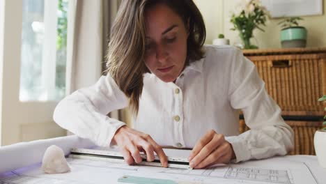 Caucasian-female-architect-interior-designer-drawing-working-from-home