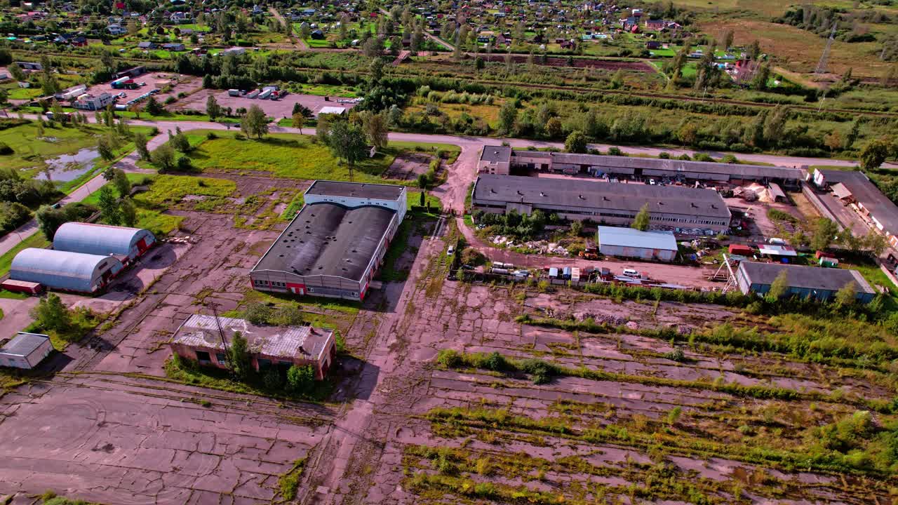 Aerial view of abandoned buildings and overgrown land in Latvia