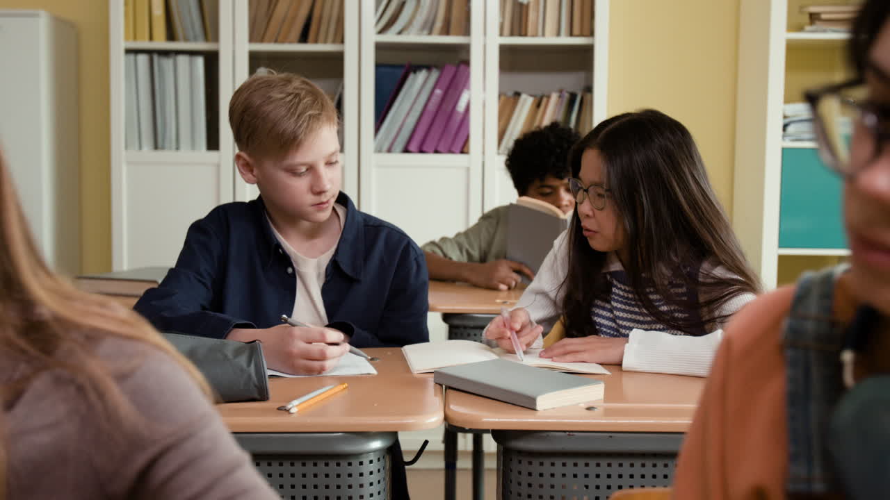 Students focused on their studies in a bright classroom