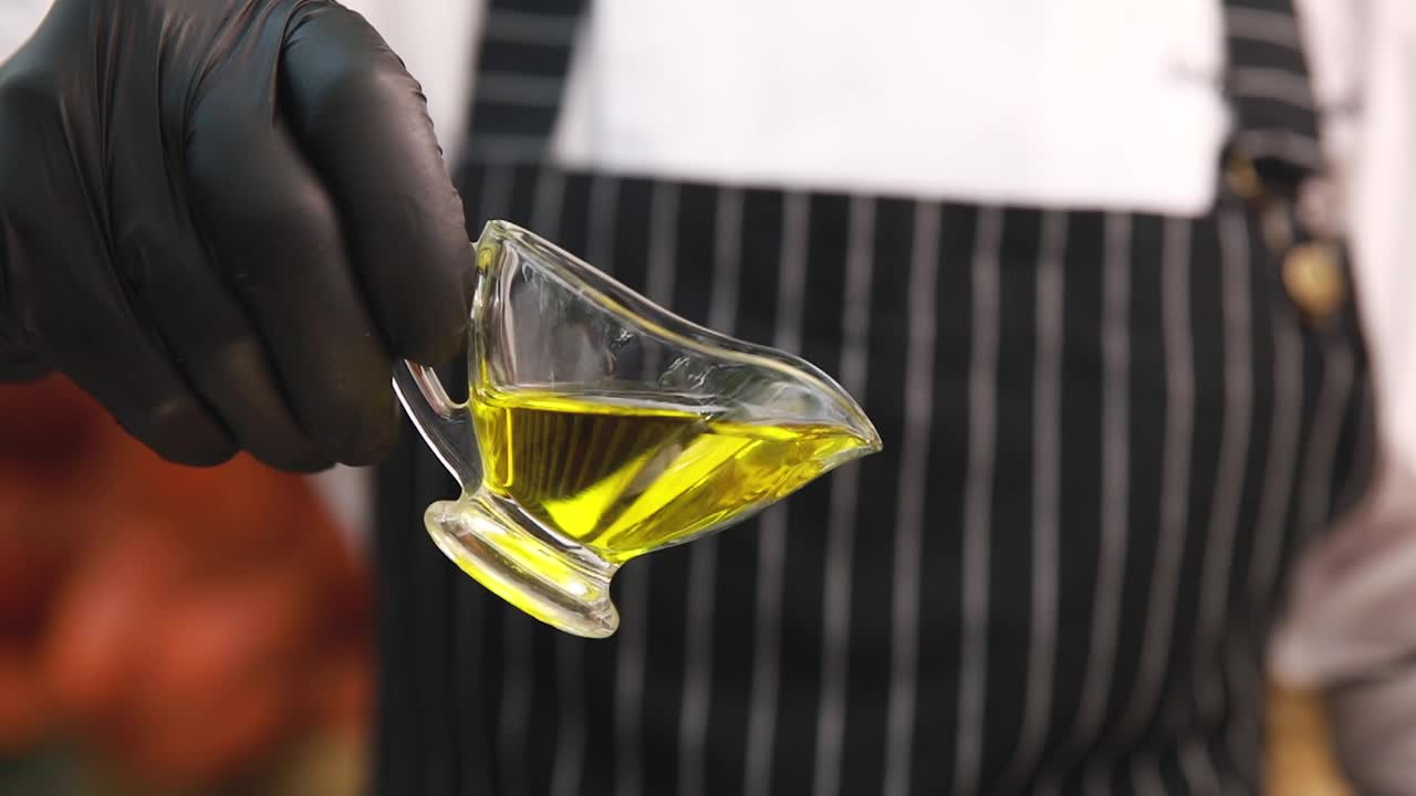 Chef pouring oil